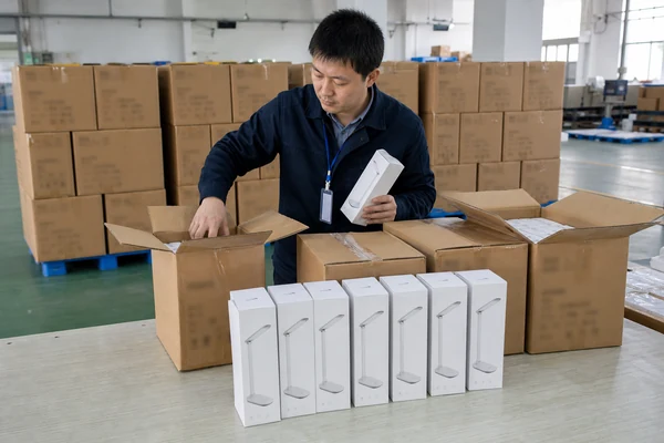 Inspector selecting random product samples from finished cartons for a bulk order